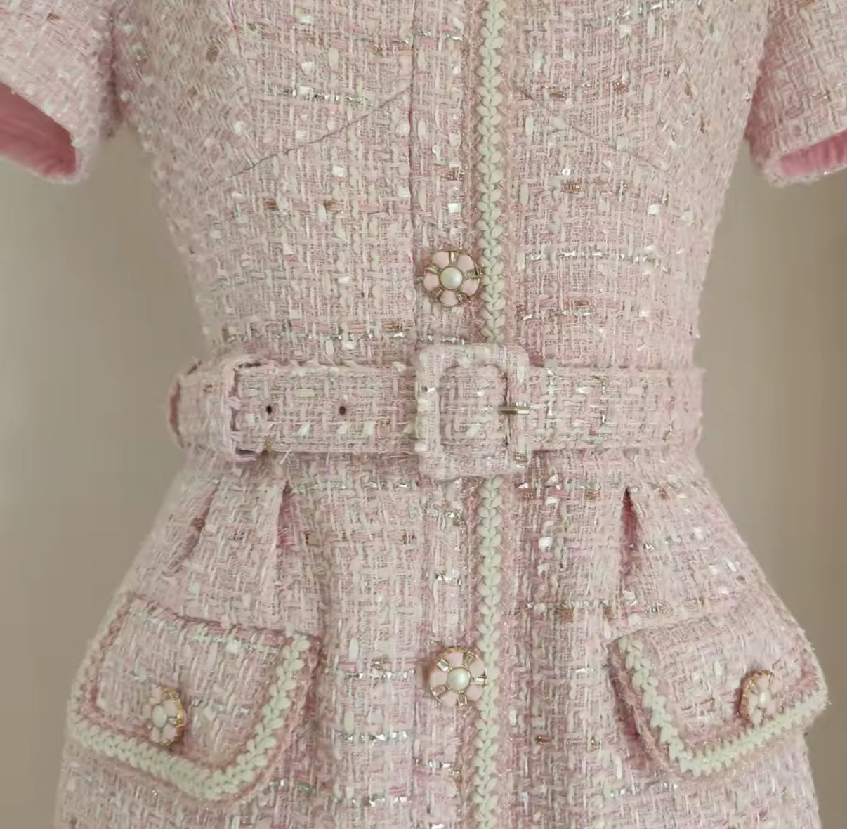 tweed mini dress with pearl buttons and a belted waist