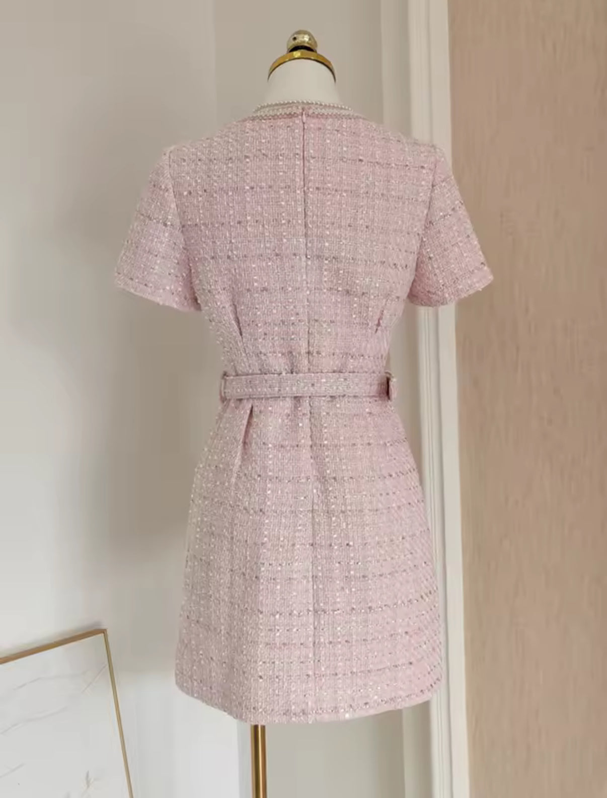 tweed mini dress with pearl buttons and a belted waist