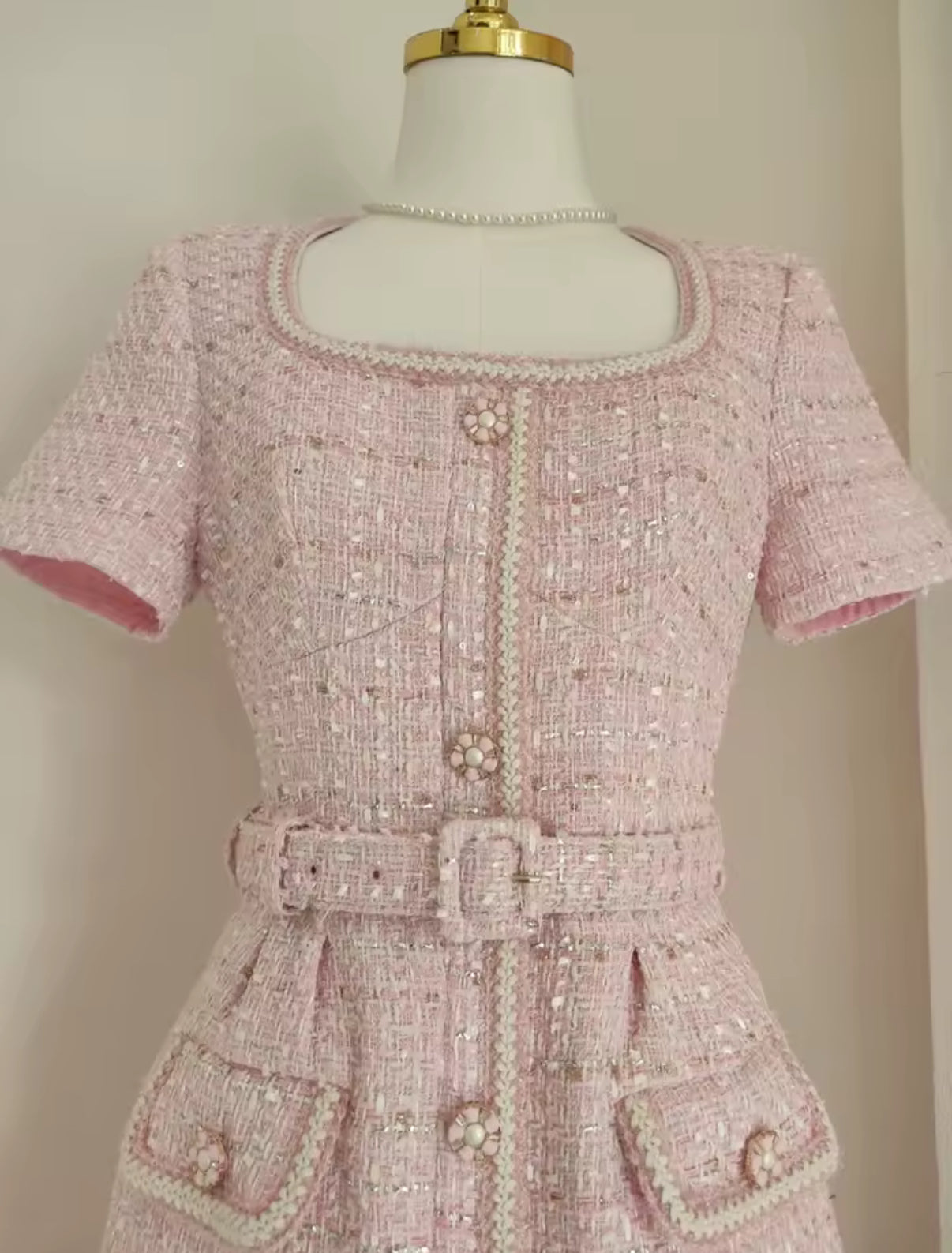 tweed mini dress with pearl buttons and a belted waist