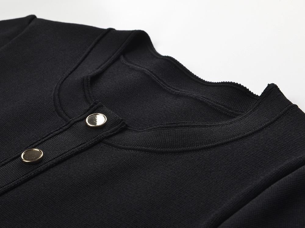 Black fitted dress with statement gold buttons and a playful pleated hem