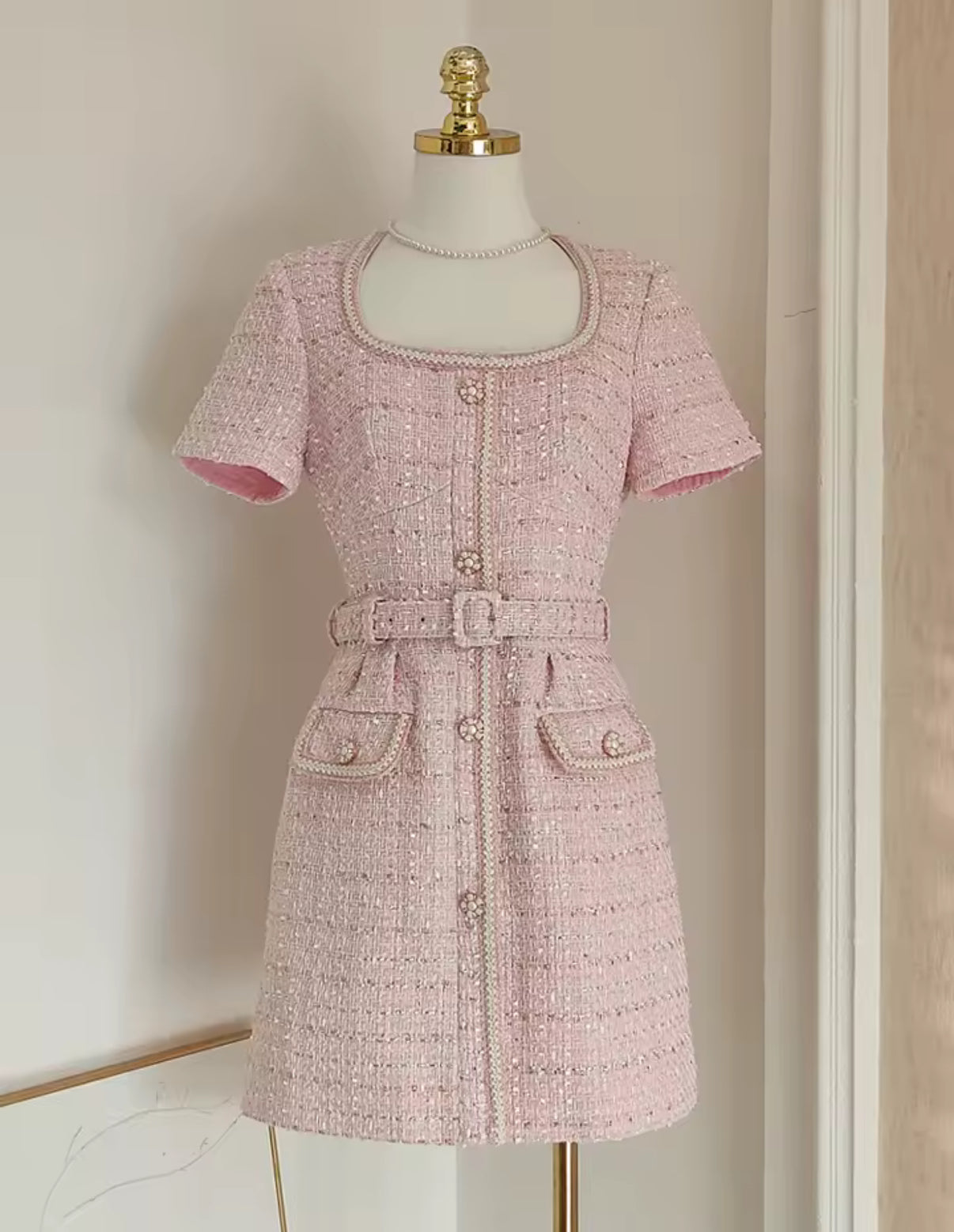 tweed mini dress with pearl buttons and a belted waist