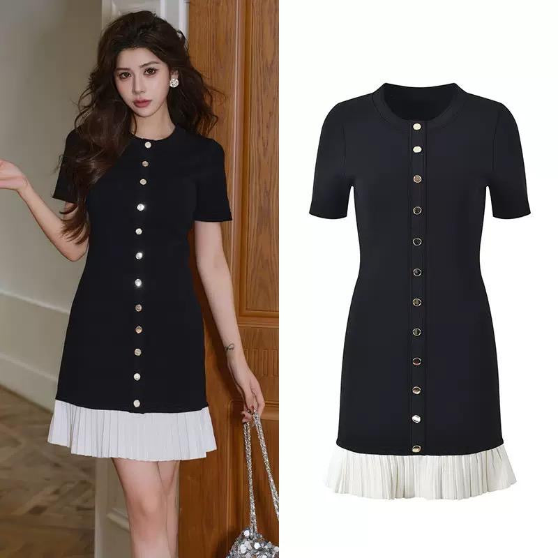 Black fitted dress with statement gold buttons and a playful pleated hem